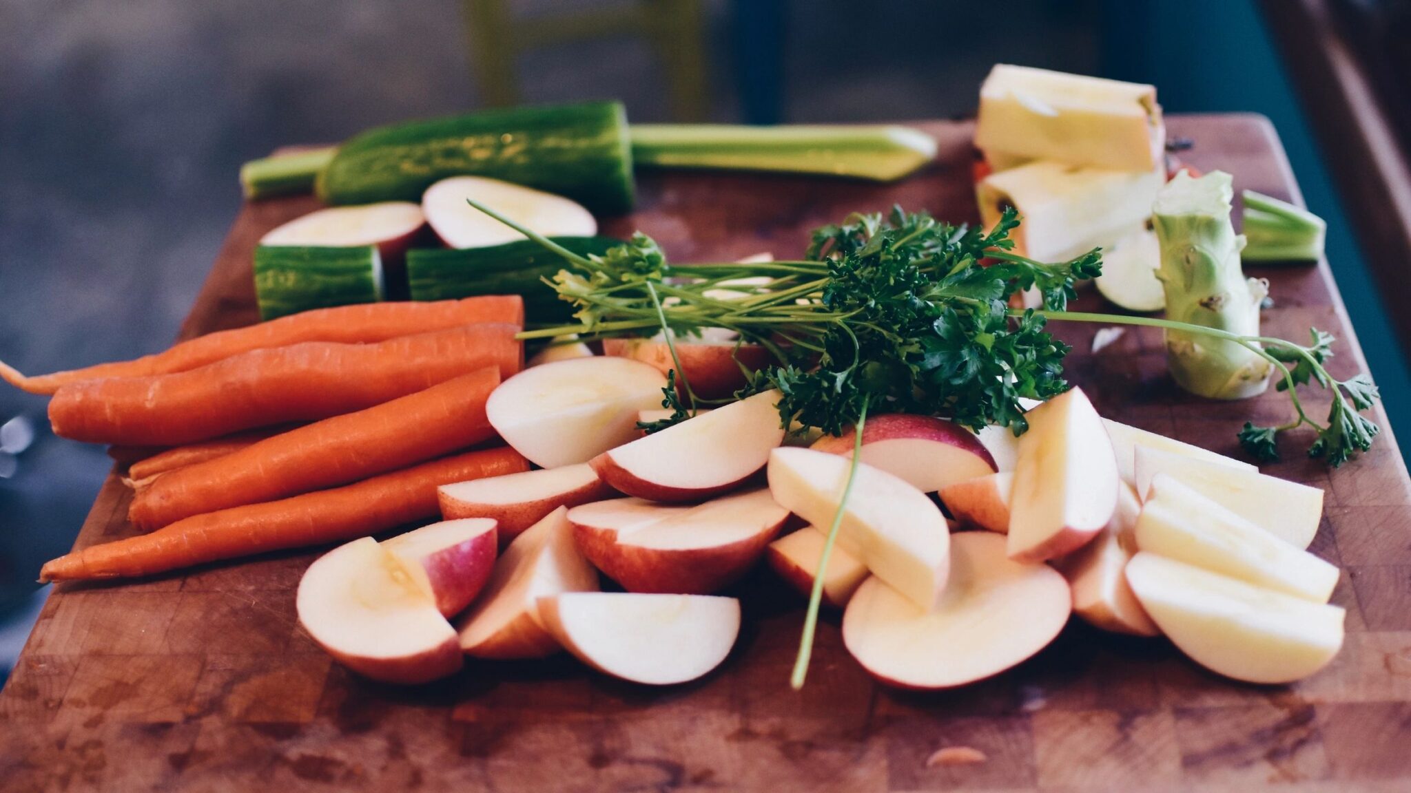 Chopped carrots, apples, and cucumbers.